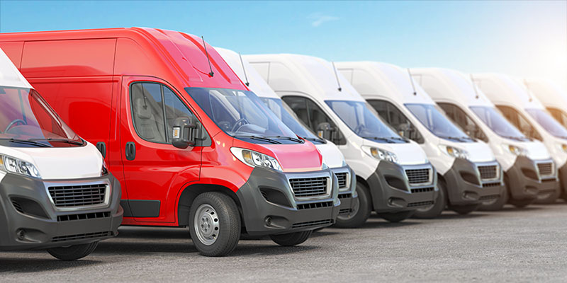 Red delivery van in a row of white vans. Best express delivery a Red delivery van in a row of white vans. Best express delivery and shipemt service concept. 3d illustration