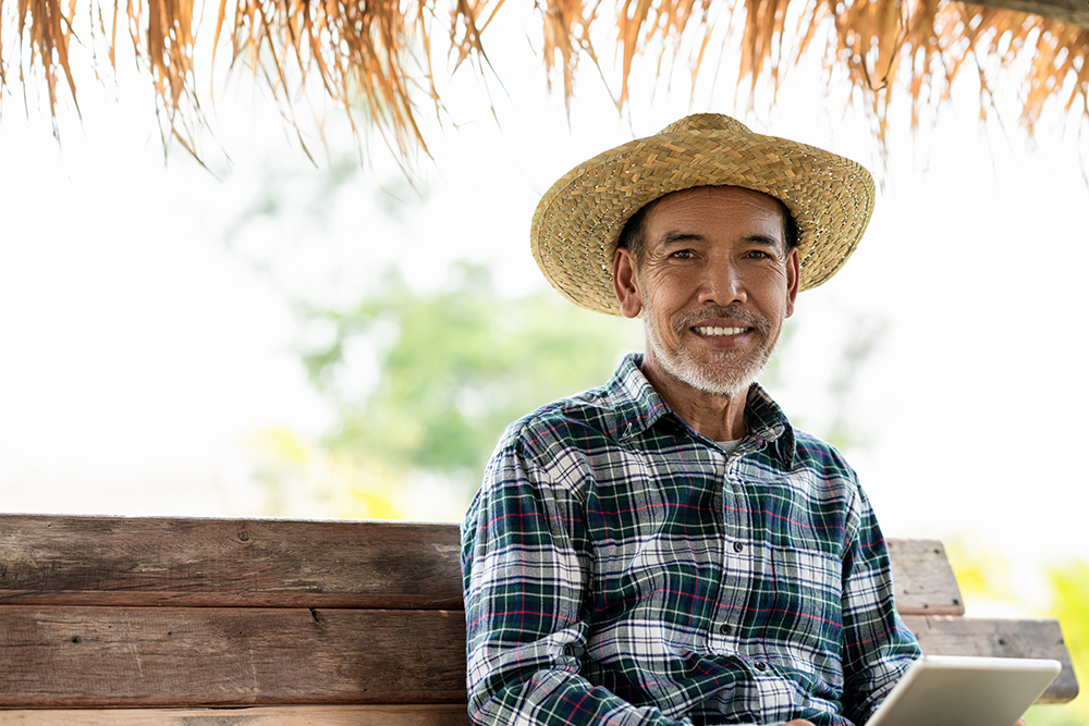 Asian Adult using Laptop Modern agriculture using laptop and internet connection