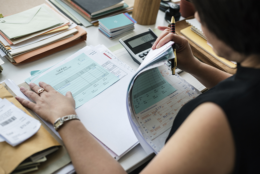 Asian woman working through paperwork Asian woman working through paperwork