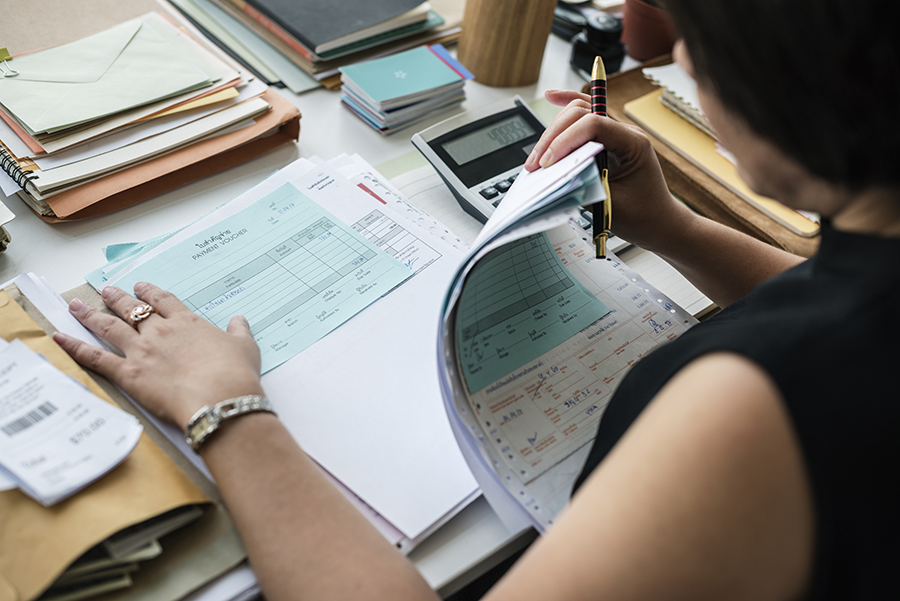 Asian woman working through paperwork