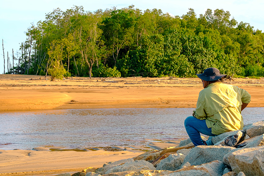 a-man-in-deep-thought-while-looking-at-river-estua-2022-11-11-21-22-15-utc